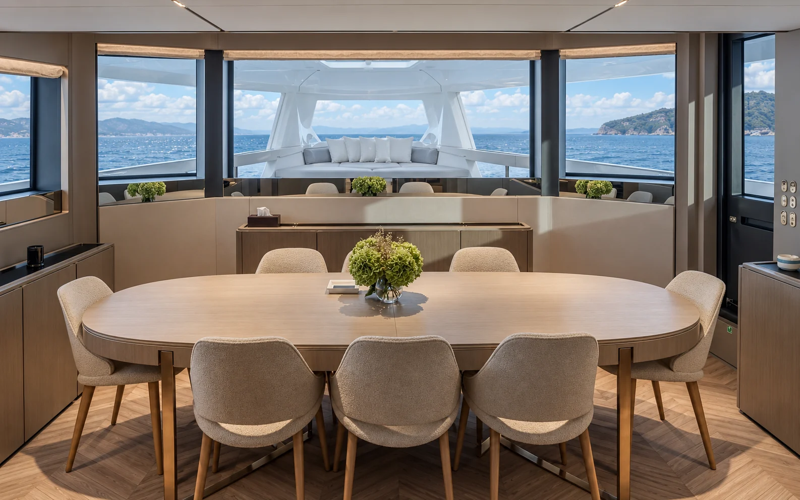 The forward dining room, looking out through the glass to the All-Season Terrace at the bow