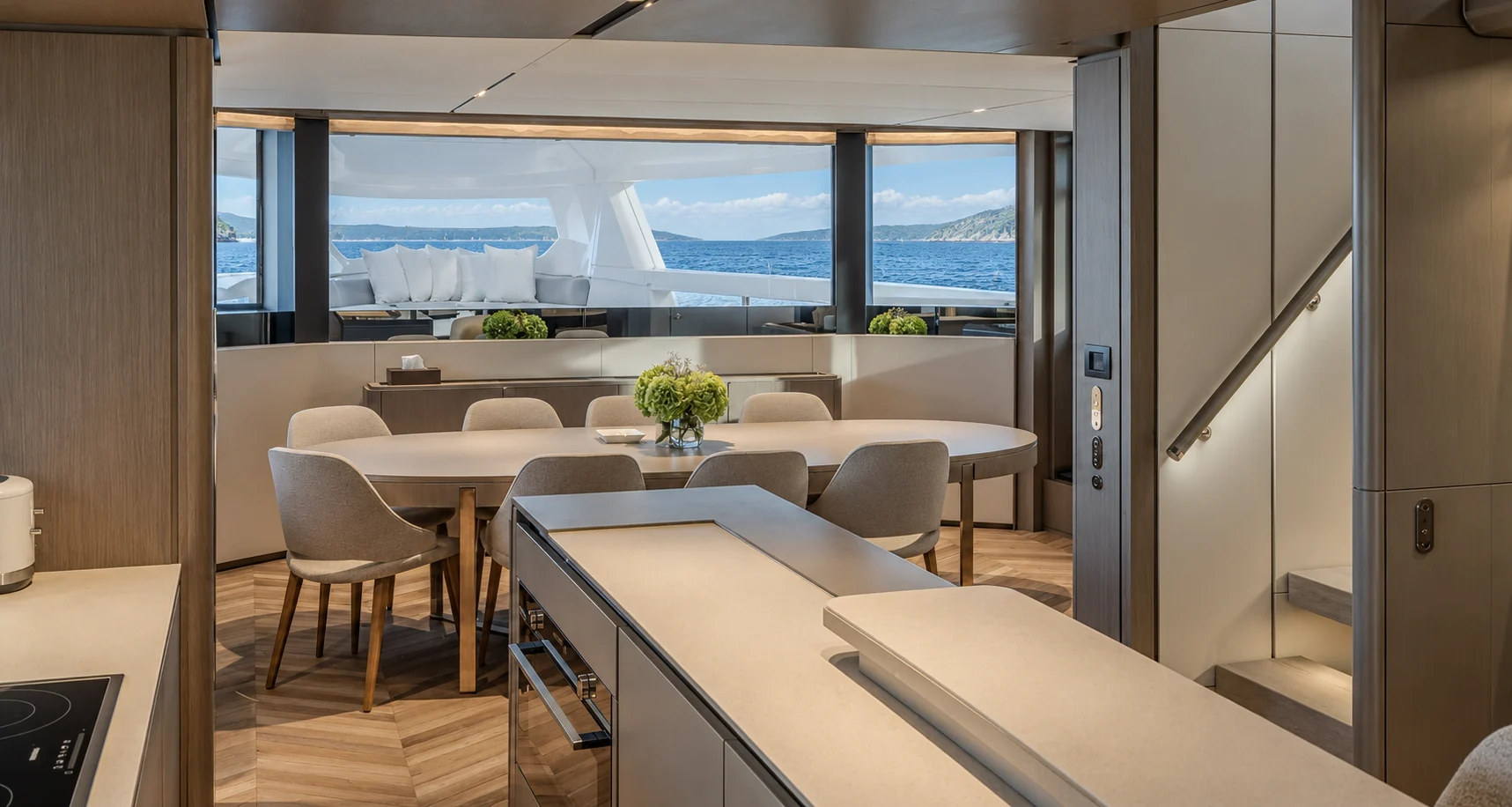 Open galley with a seated counter, and the dining table for eight beyond