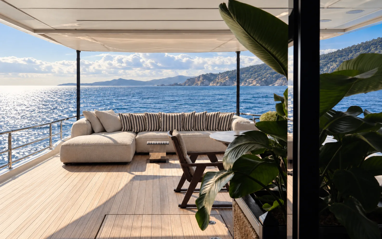 Aft deck lounge with sofas and planters, open to the sea
