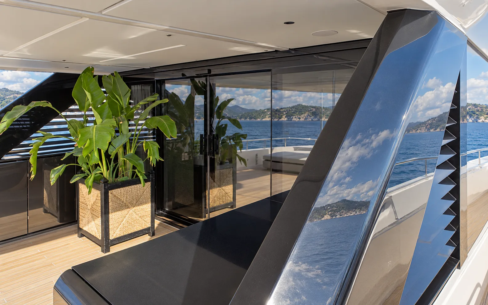 Corner of the aft deck with a planter beside the saloon glass