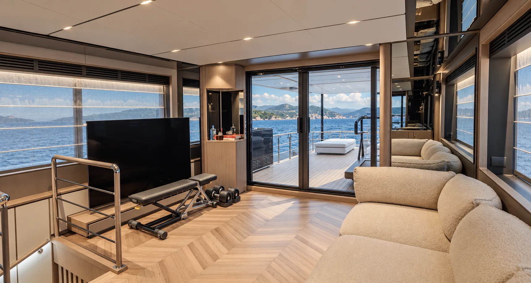 Upper saloon with a screen and glass doors to the deck