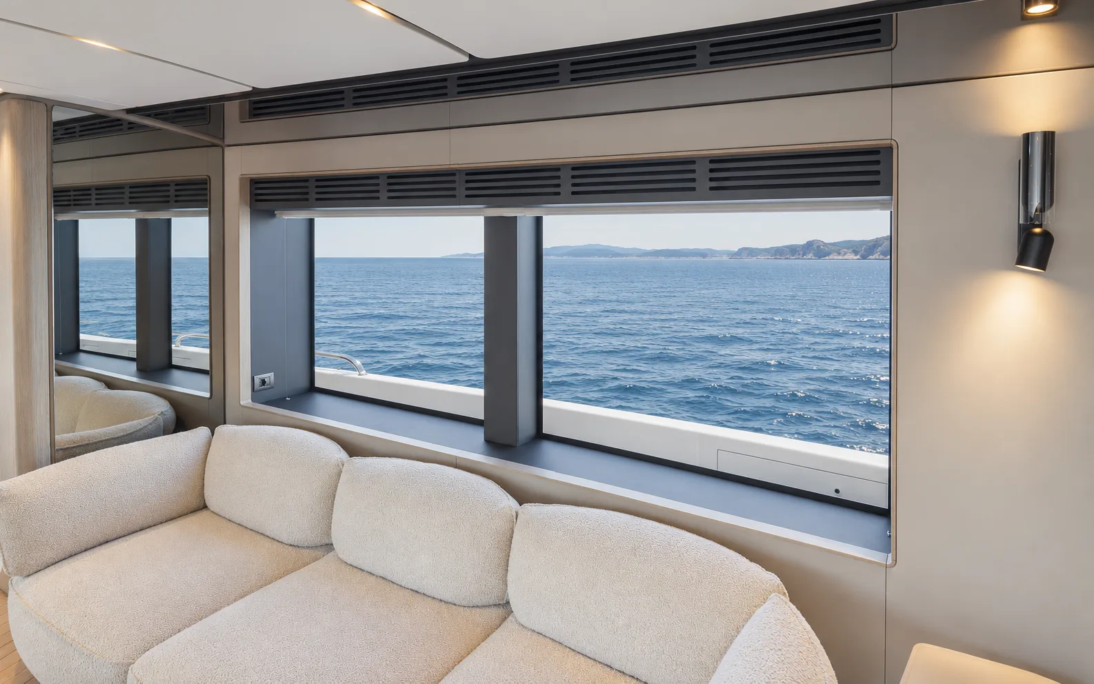 Upper saloon sofa beneath wide windows