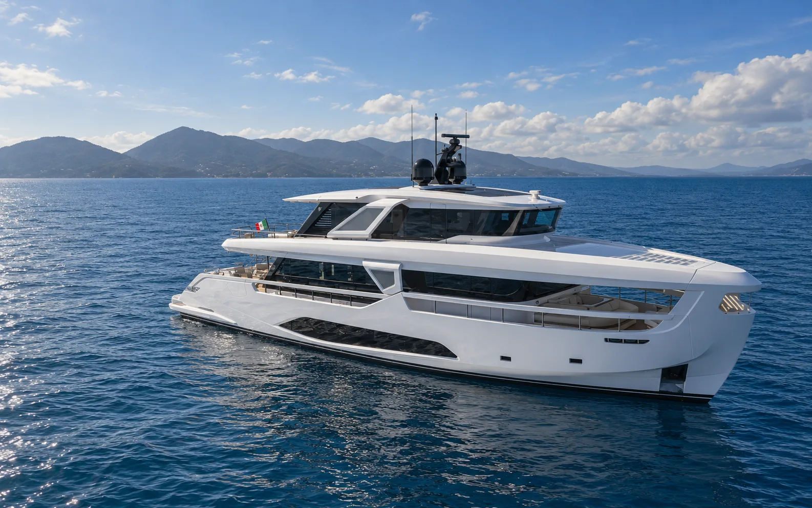 Three-quarter view from the bow, with the hills behind