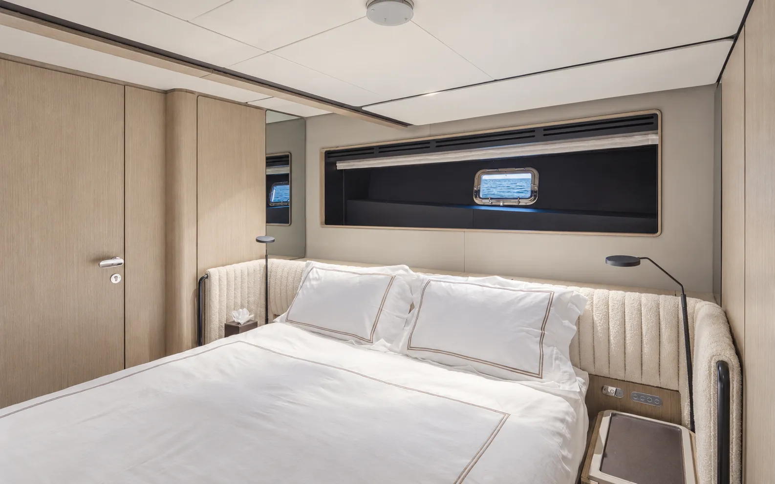Double cabin with a hull window above the bed